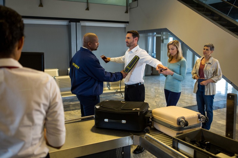 security-guard-frisk-passengers-standing-queue-scaled