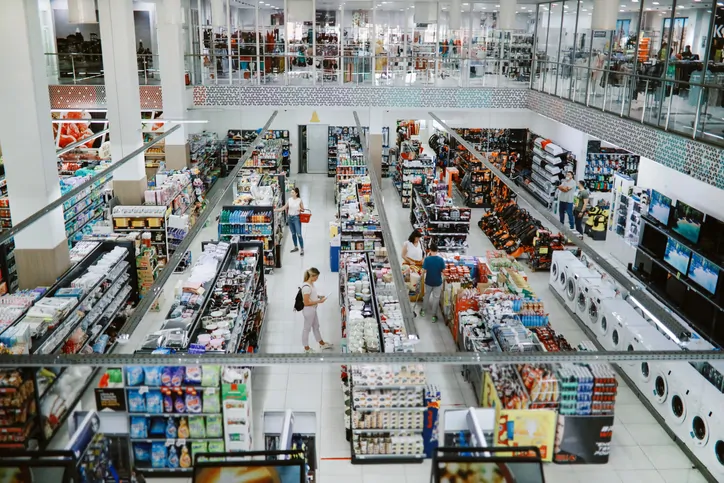 Overhead image of people buying in the large supermarket.